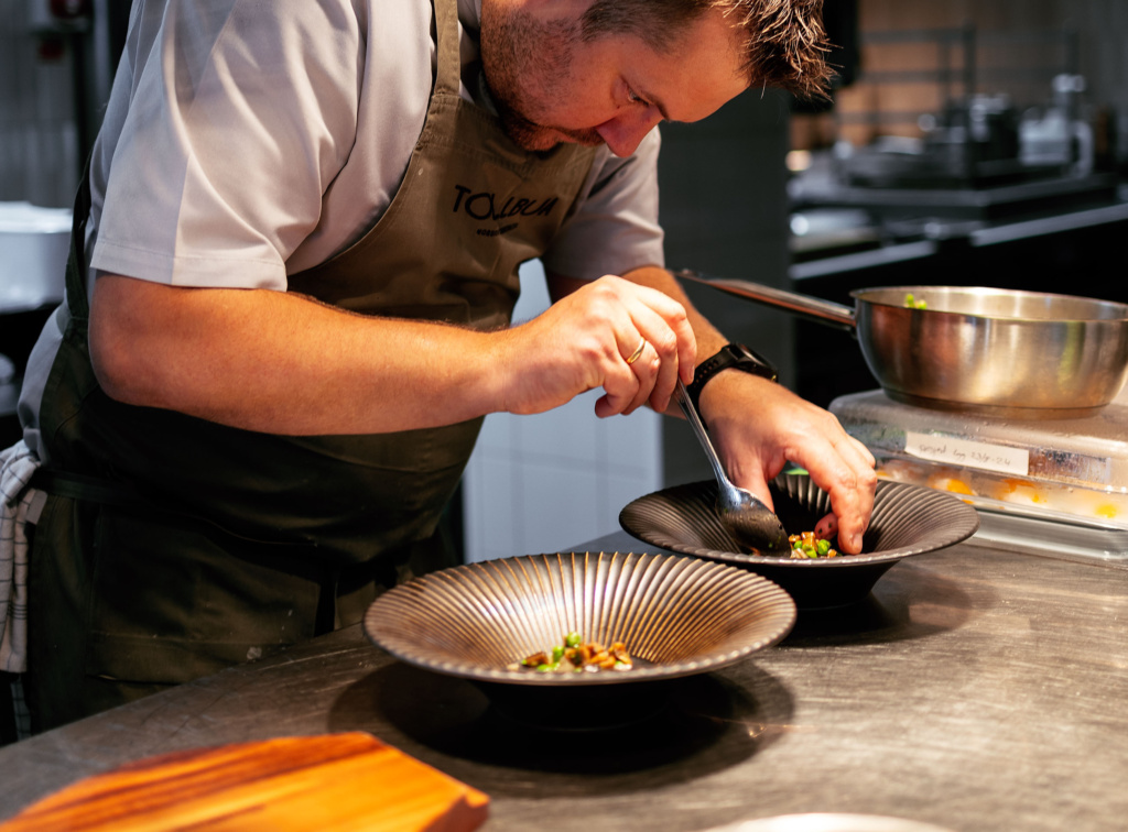 Chef Christopher Davidsen platting lunch dishes at Tollbua Restaurant