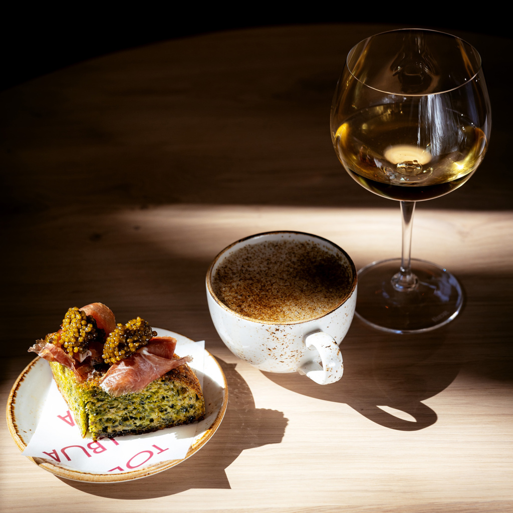 Tors bread at Tollbua restaurant, served with caviar, shiitake mushroom cappuccino and glass of white wine