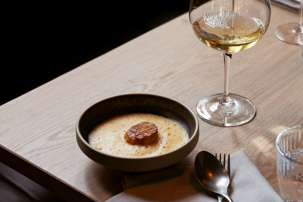 Scallops dish at Tollbua, served with Beurre Blanc, carrot curry, and turnips