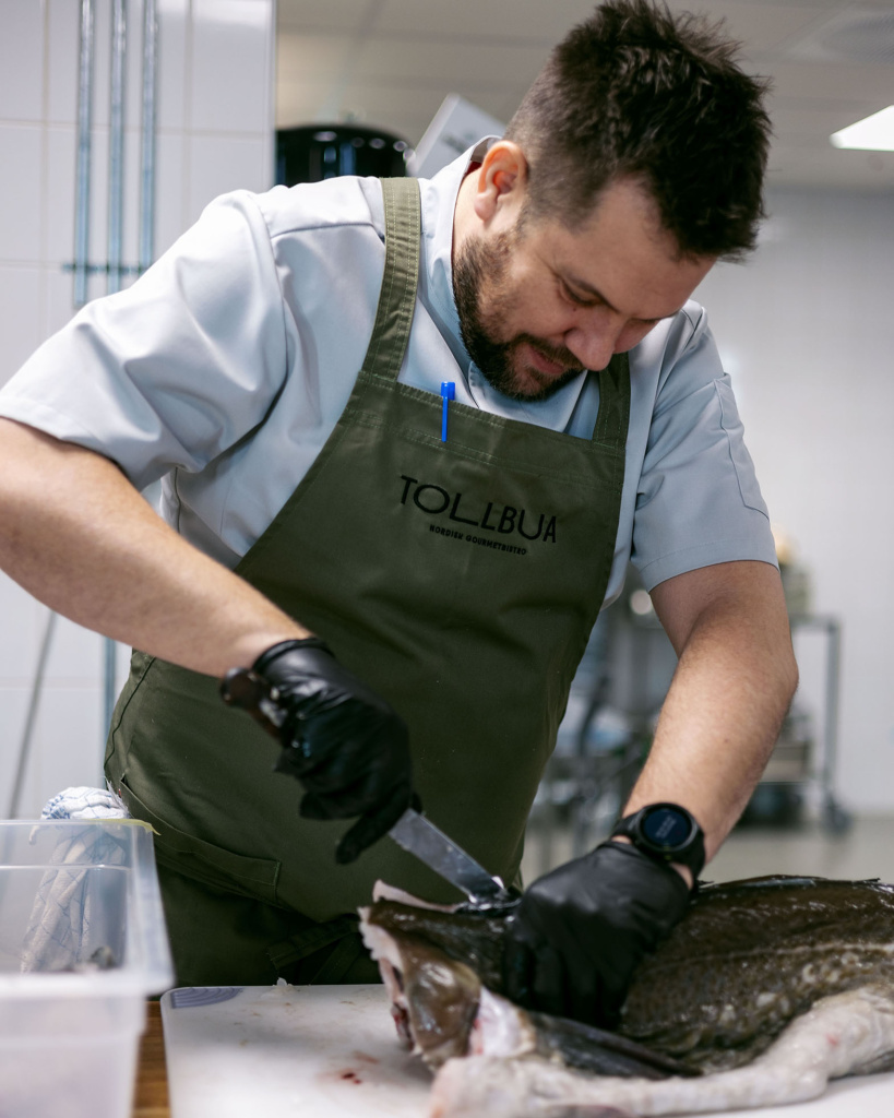 Christopher Davidsen working with fish in Tollbua's kitchen